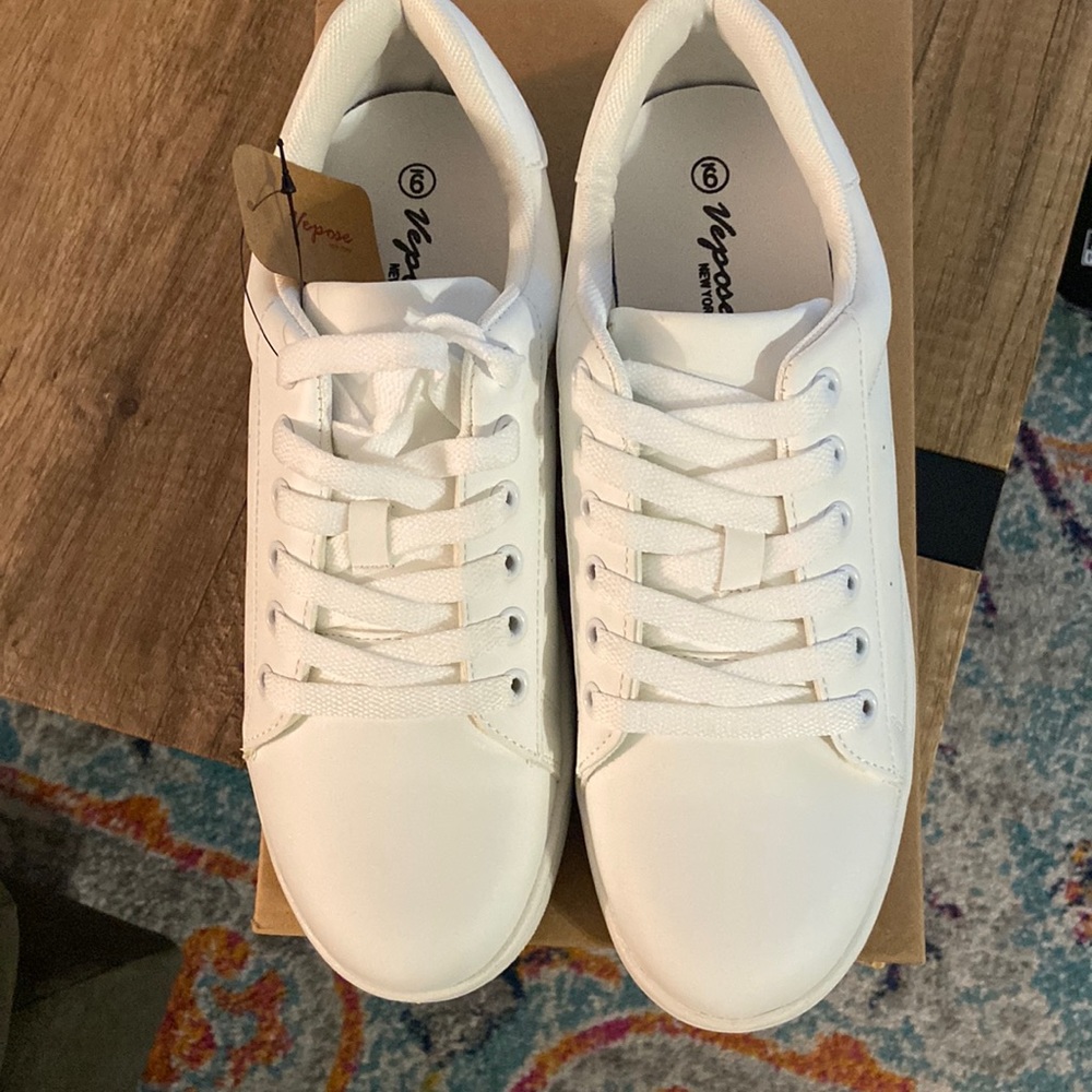 Never worn white tennis shoes. Perfect condition with extra laces